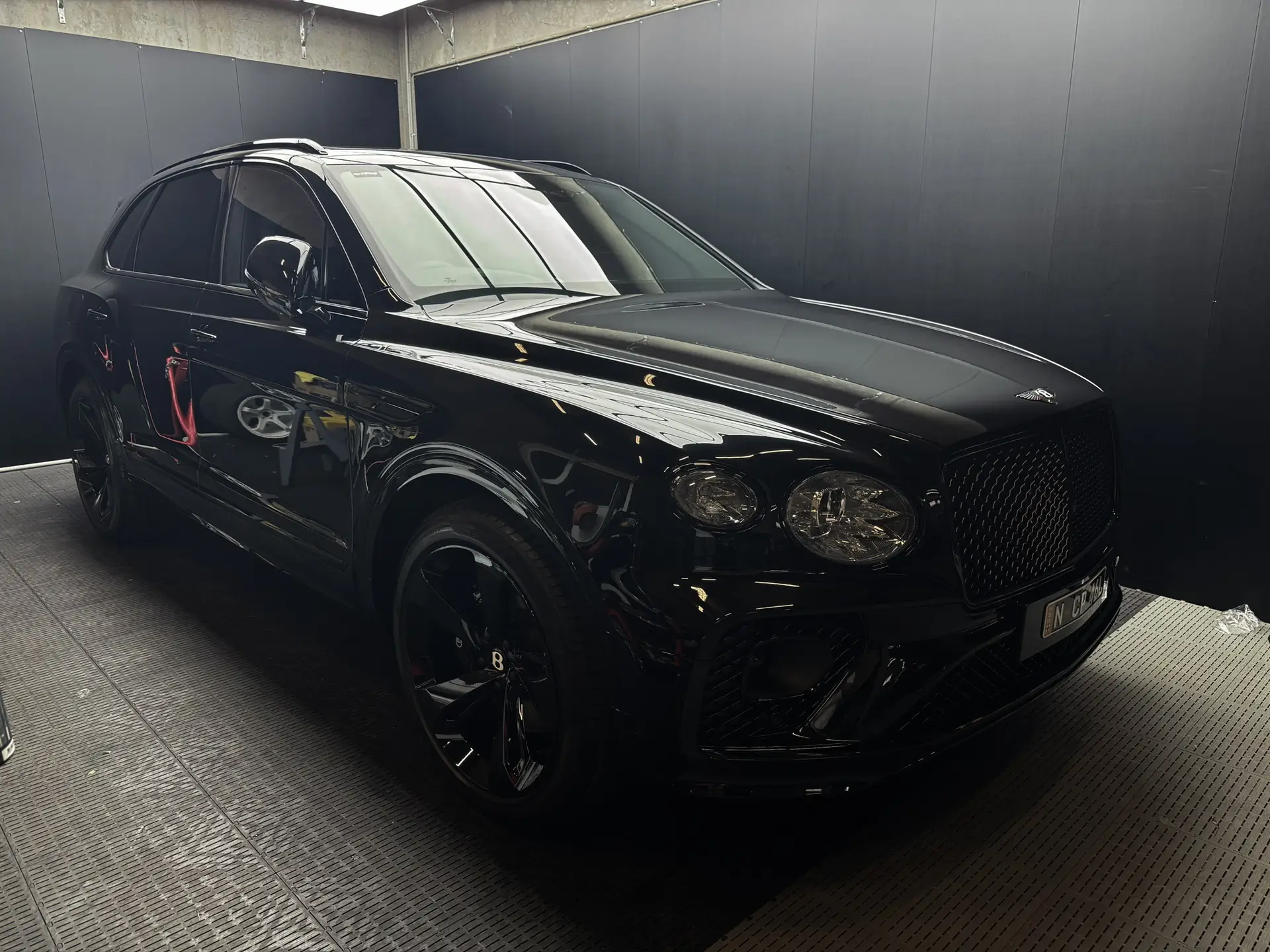 Black Bentley Bentayga full vehicle wrap showing front bumper PPF and bonnet protection work.